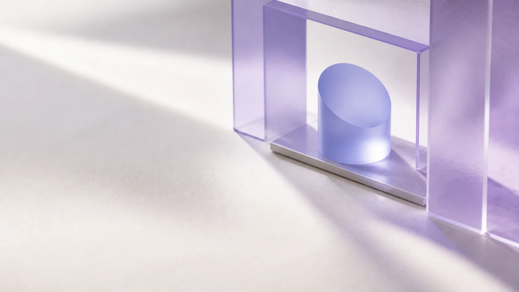 A lavender architectural aperture framing a small periwinkle glass sculpture