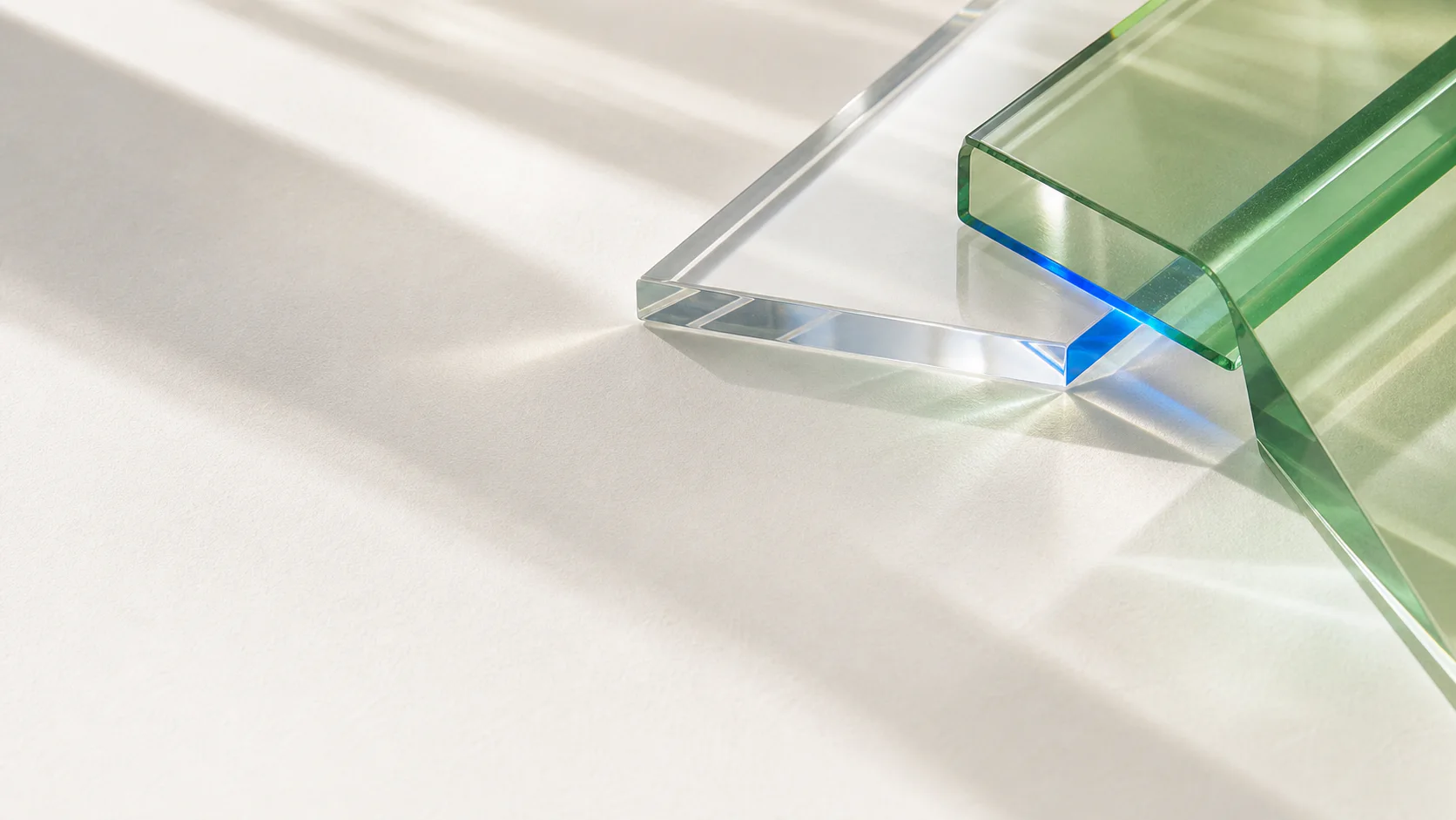 Fresh green and clear optical glass refracting cobalt light in a bright studio